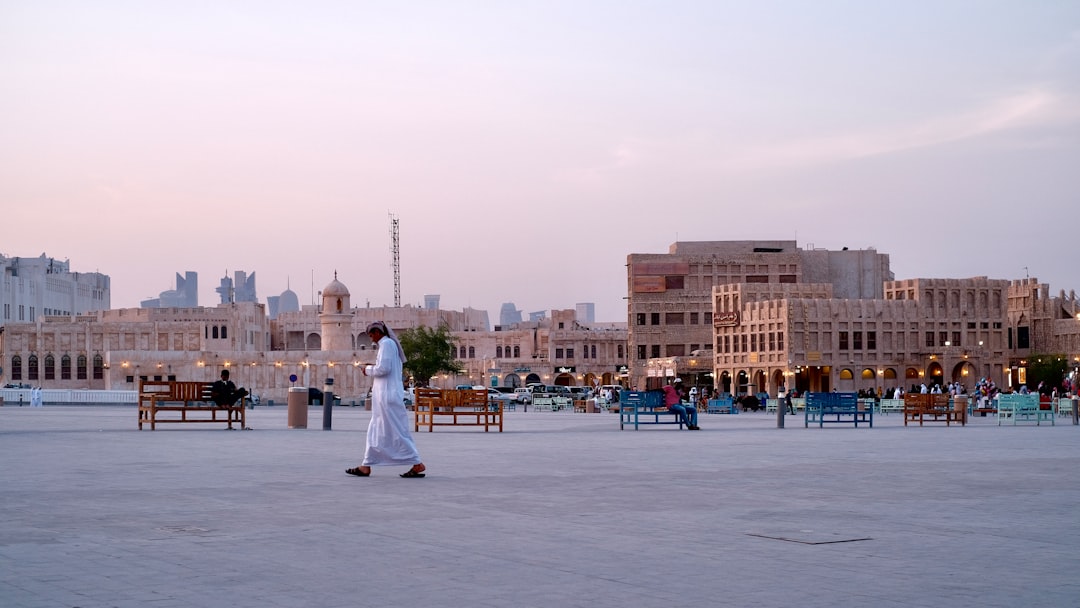 People walking through Souq Waqif market in Doha, Qatar.
